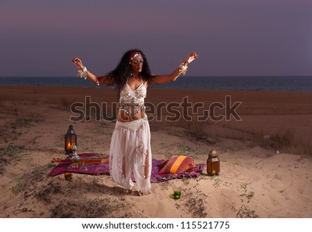 Oriental dance on top of a scenic coastal dune