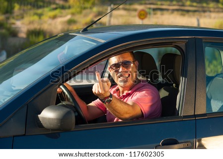 Male driver in a road rage attitude