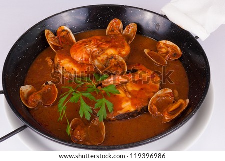 Pan containing hake in cider sauce