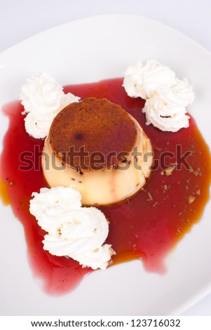 Creme caramel in a delicious red bilberry sauce