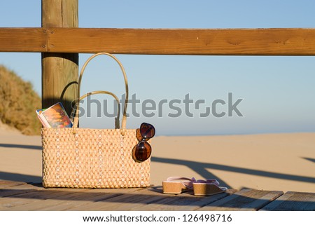 A handbag full with all basics for a relaxing day on the beach