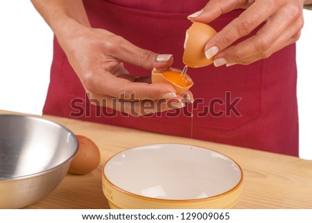 Female hands separating the white from the yolk