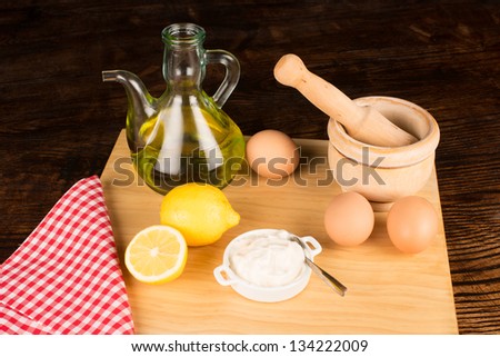 Preparing mayonnaise, the main ingredients on a kitchen board