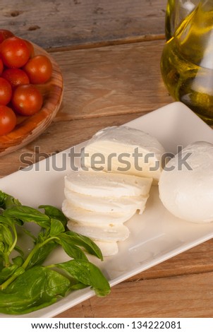 Freshly chopped mozzarella surrounded by salad ingredients
