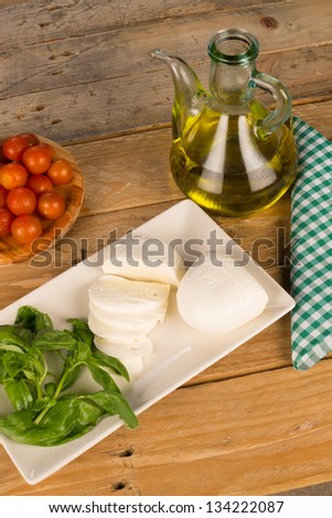 Freshly chopped mozzarella surrounded by salad ingredients
