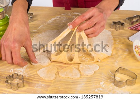 Preparing fancy shaped cookies with some pastry cutters