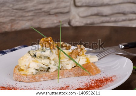 Blue cheese appetizer with walnuts and  glazed with honey