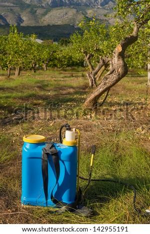 Pesticide sprayer against the background of an orchard