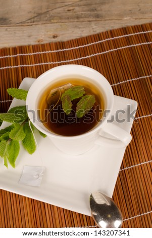Freshly made tea scented with spearmint leaves