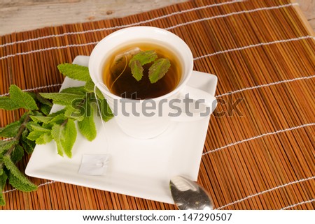Freshly made tea scented with spearmint leaves