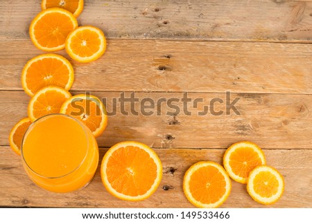 Orange slices and juice against a rustic background