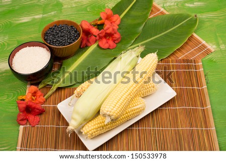 Corn on the cob in a still life with other Latin American food staples
