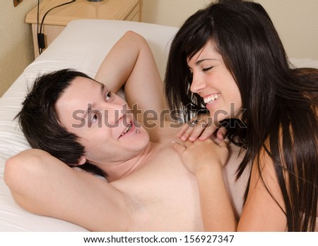 Relaxed and happy couple  laughing in bed