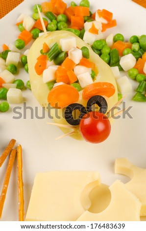 A  kid salad  with cheese decorated as a mouse