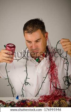 Guy tangled in between a mess of party decoration