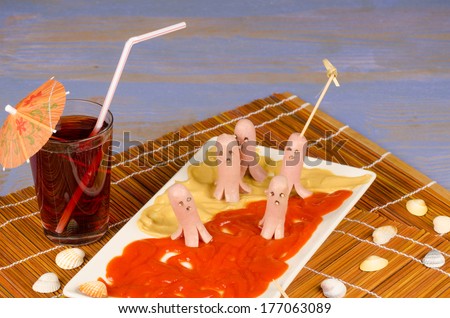 Funny sausages swimming in a sauce sea, a kid snack