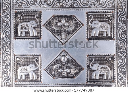 Traditional Indian engravings on metal displaying elephants