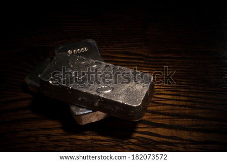 A low key still life with several  silver bars