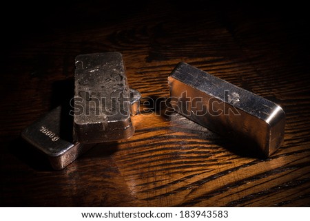 Still life with silver bars on a wooden background