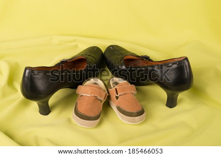 Kids sandals and moms shoes in a still life