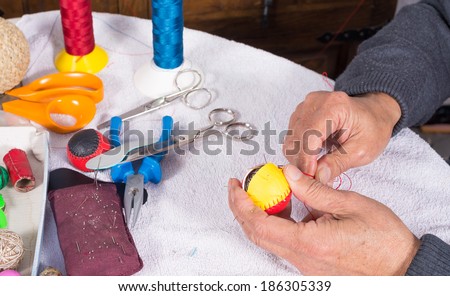 Skilled hands crafting leather balls for traditional pelota sport