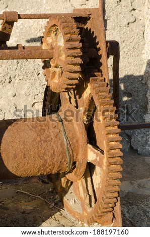 An old rusty machine with big cog wheels