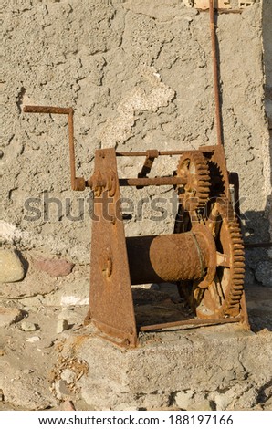 An old rusty machine with big cog wheels