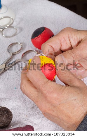 Expert hands  sewing traditional sport balls