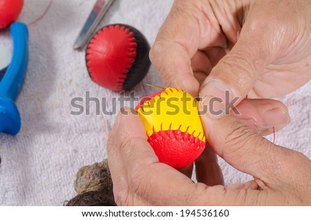 Expert hands crafting traditional sport balls