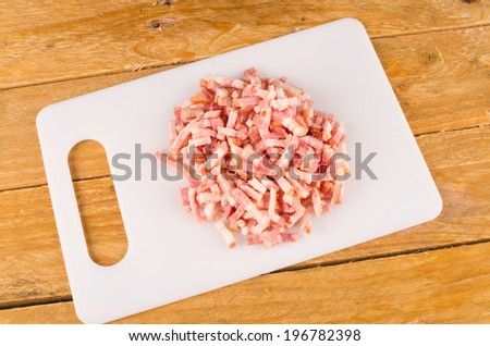Diced bacon on a  chopping board, cooking ingredient