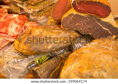 Assorted serrano ham on display on a market stall