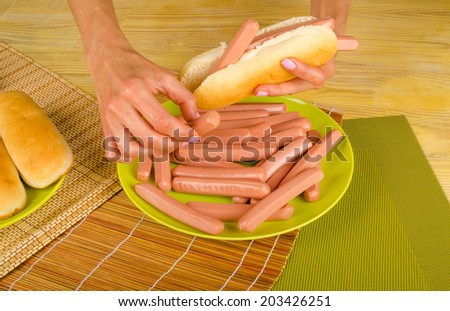 A hot dog to be stuffed with a lot of sausages, an unhealthy food concept