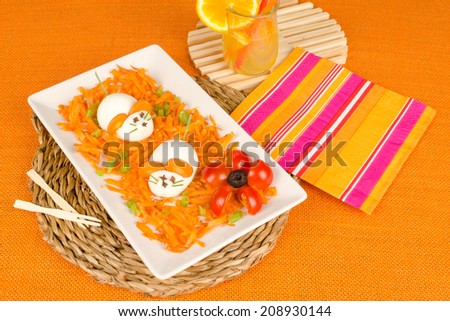 Funny carrot salad decorated with eggs in the shape of  mice, a kid meal
