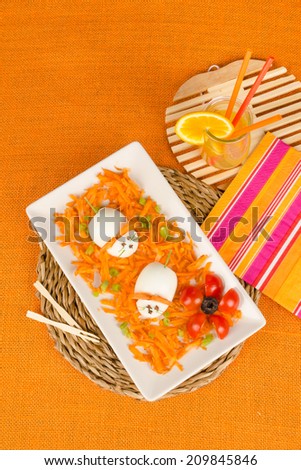 Funny carrot salad decorated with eggs in the shape of  mice, a kid meal