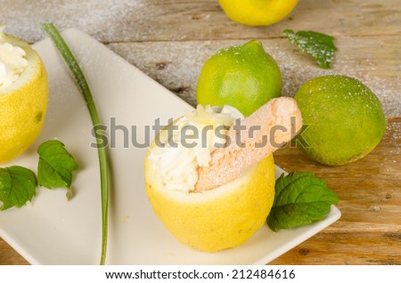 Fresh lemons around a homemade lemon sorbet