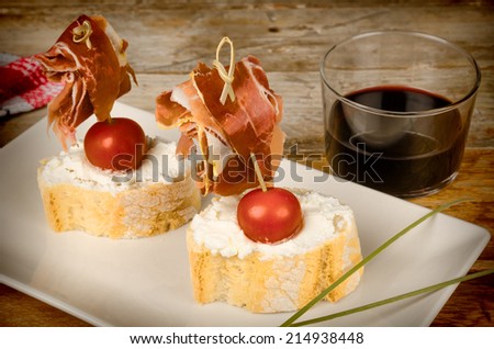 Serrano ham tapa served on bread with goat cheese