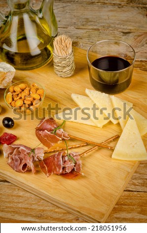 An assortment of Spanish snacks on a wooden board