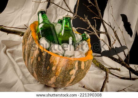 Bottles of fizzy drink inside a pumpkin