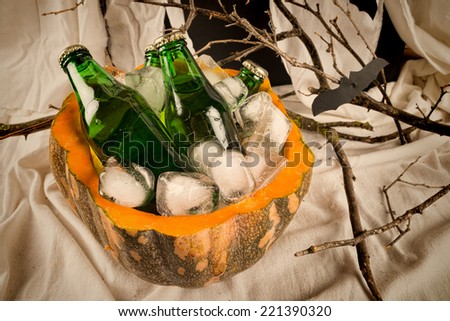 Bottles of fizzy drink inside a pumpkin