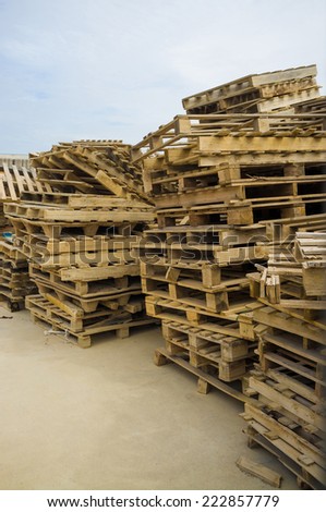 Pile of used pallets stacked in an industrial backyard
