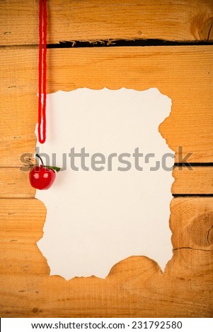 Parchment for a Christmas wish list against a rustic wooden background