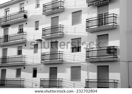 Full frame black and white take of a shabby apartment block