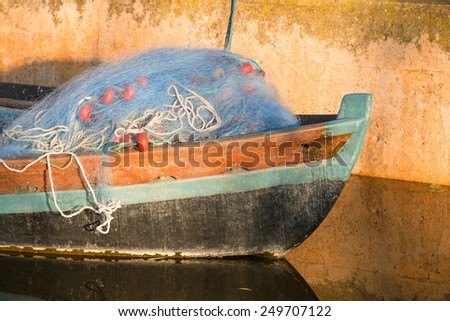 Old boat with fishing nets on its prow