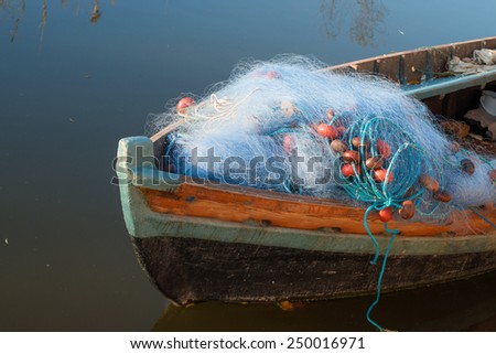 Old boat with fishing nets on its prow