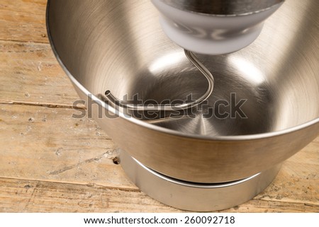 Steel bowl of a food processor with an attached dough hook