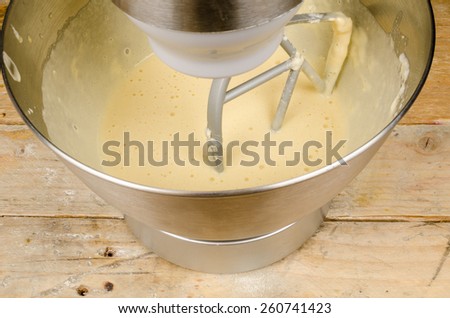 Food processor with beater tool preparing dough for a cake