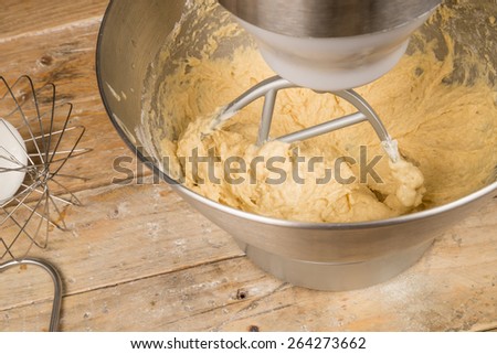 Food processor with beater tool preparing dough for a cake