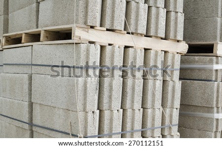 Many concrete blocks piled up on a construction material yard