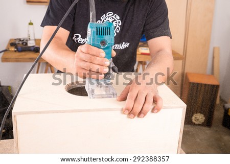 Milling machine being used to craft a cajon flamenco percussion instrument