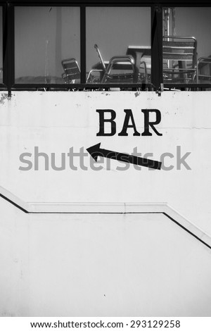 Bar sign pointing towards a roof terrace